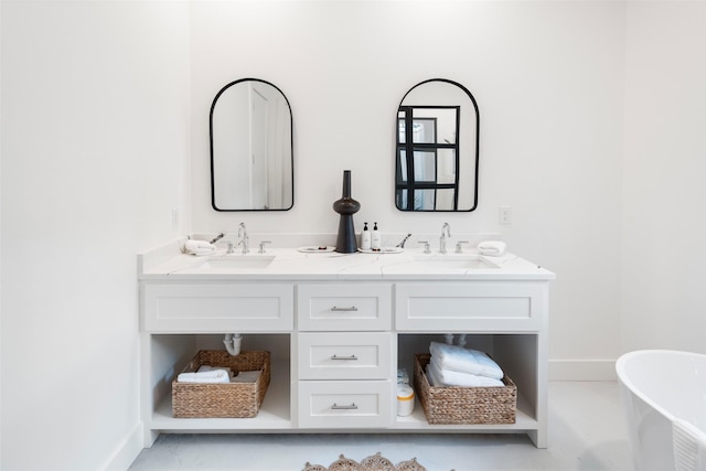 23502 Kate Ln, Arp, TX 75750 - bathroom with a freestanding bath, double vanity, and baseboards