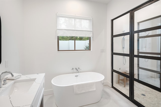 bathroom with vanity, concrete floors, and a bathtub