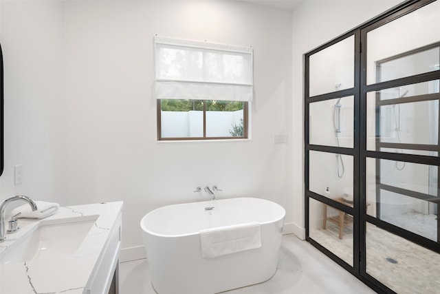 23502 Kate Ln, Arp, TX 75750 - bathroom with a soaking tub, baseboards, and vanity