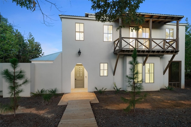 23502 Kate Ln, Arp, TX 75750 - view of front facade featuring a balcony, stucco siding, and metal roof