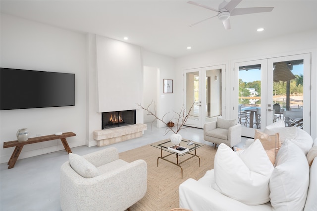 living room featuring french doors, a large fireplace, and ceiling fan