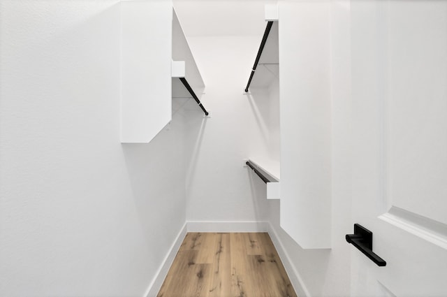 walk in closet featuring light hardwood / wood-style flooring