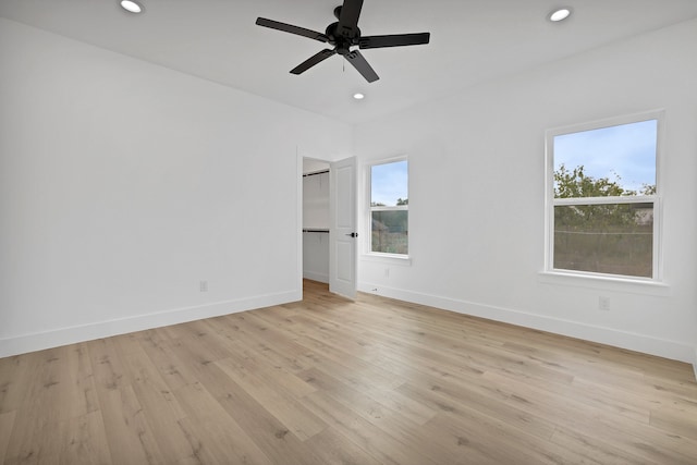 unfurnished room with ceiling fan and light wood-type flooring