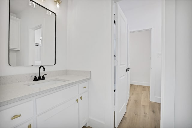 bathroom featuring vanity and wood-type flooring