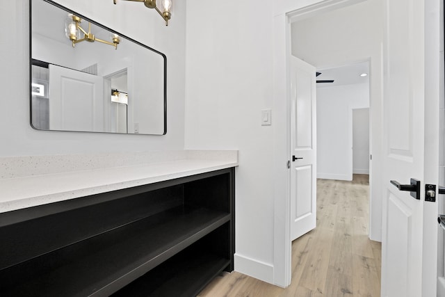 bathroom featuring ceiling fan, vanity, and hardwood / wood-style flooring