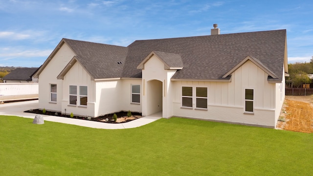 back of house with a lawn