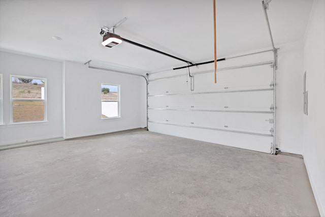 garage featuring electric panel and a garage door opener