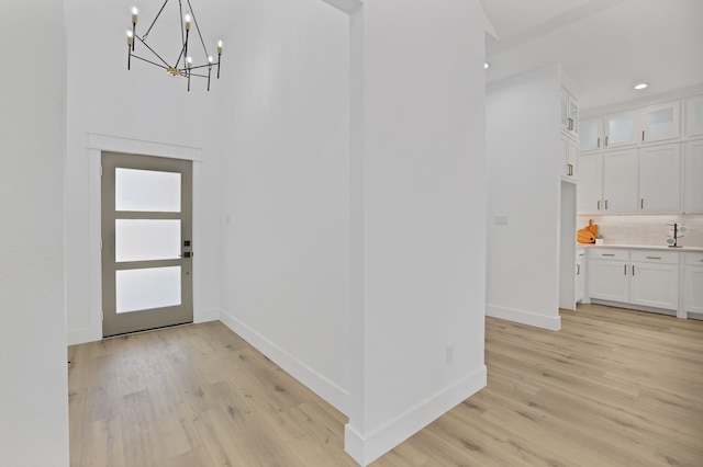 entryway featuring a chandelier and light hardwood / wood-style flooring