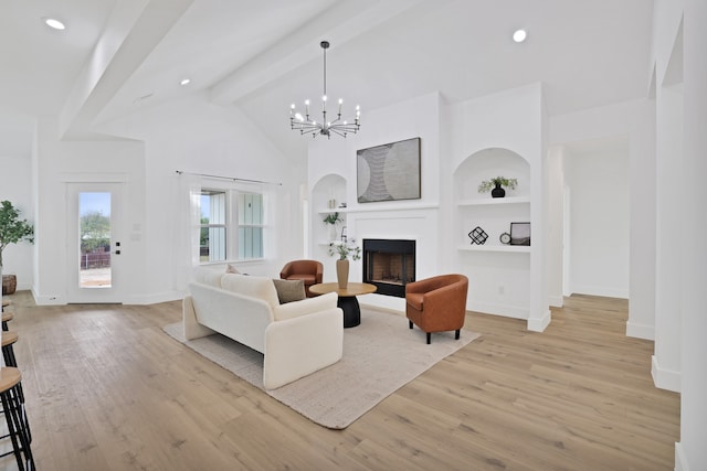 living room featuring beamed ceiling, built in shelves, light hardwood / wood-style floors, and a notable chandelier