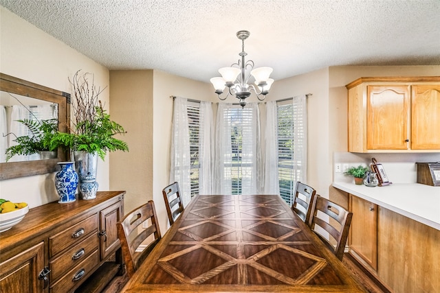 dining area with a chandelier and a textured ceiling