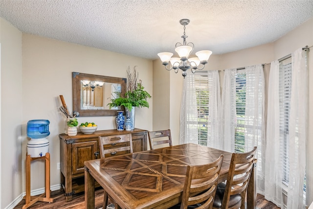 dining area featuring a chandelier, a textured ceiling, and hardwood / wood-style flooring