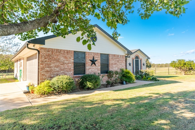 ranch-style home with a garage and a front yard