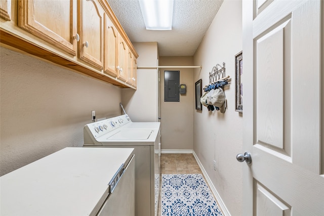 laundry area with cabinets, a textured ceiling, light tile patterned floors, washing machine and clothes dryer, and electric panel