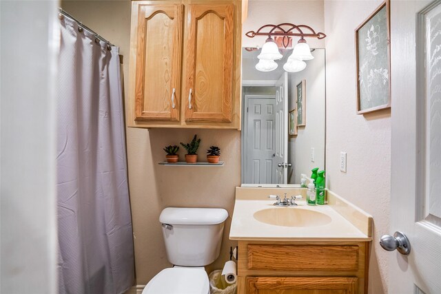 bathroom with vanity, toilet, and walk in shower