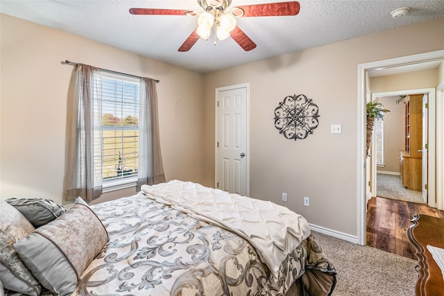 bedroom featuring hardwood / wood-style floors, a textured ceiling, and ceiling fan