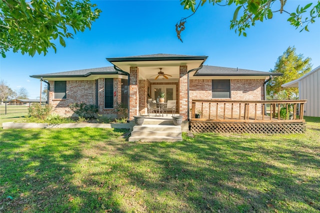 back of property featuring ceiling fan, a yard, and a wooden deck