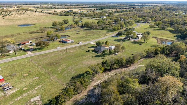 birds eye view of property featuring a water view and a rural view