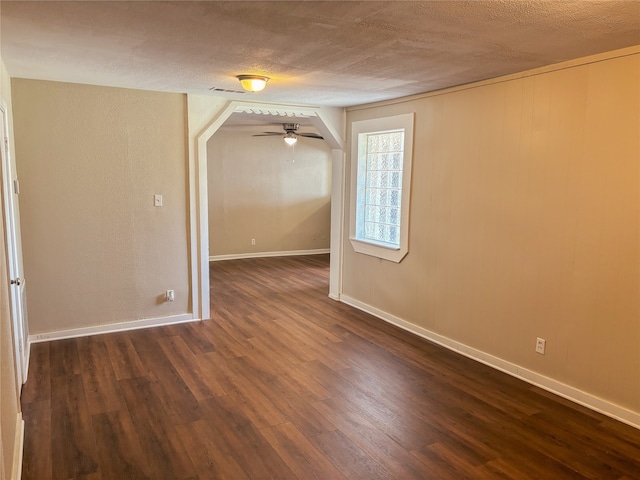 spare room with ceiling fan, dark hardwood / wood-style flooring, and a textured ceiling