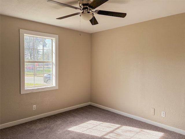 empty room featuring carpet flooring, plenty of natural light, and ceiling fan