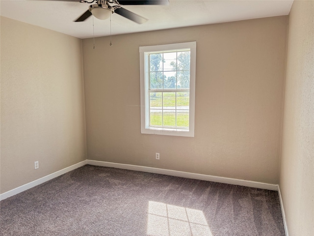 carpeted empty room featuring ceiling fan