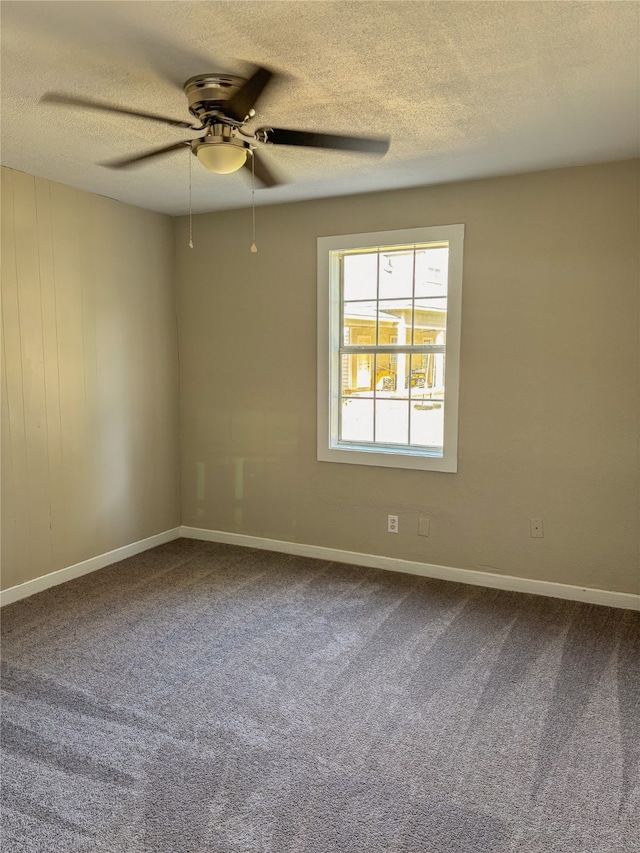 unfurnished room featuring a textured ceiling, carpet floors, and ceiling fan