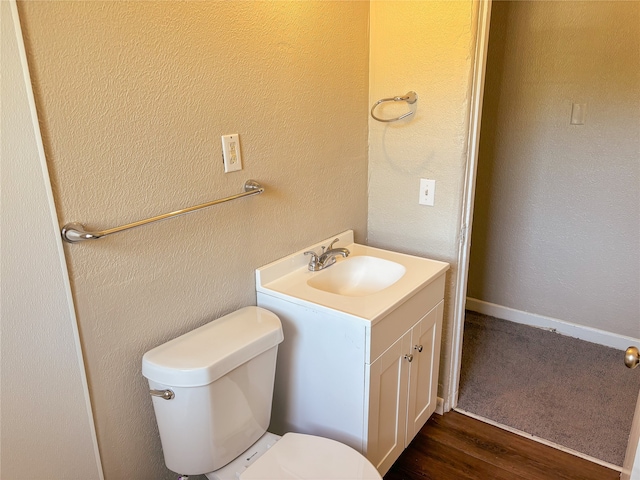 bathroom featuring vanity, toilet, and wood-type flooring