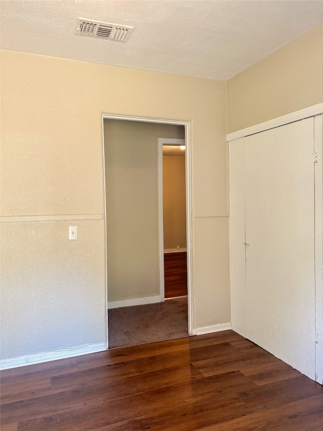 spare room with dark wood-type flooring