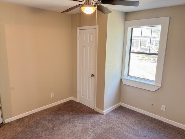 carpeted empty room featuring ceiling fan