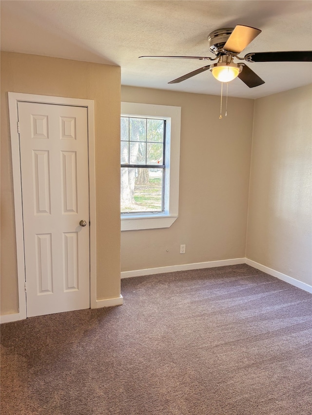 carpeted empty room with ceiling fan