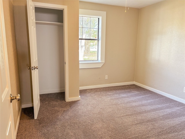 unfurnished bedroom featuring dark carpet