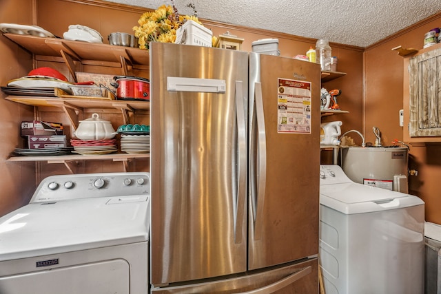 washroom featuring washer / dryer, a textured ceiling, and electric water heater