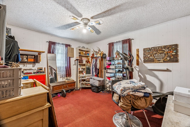 interior space featuring ceiling fan and carpet