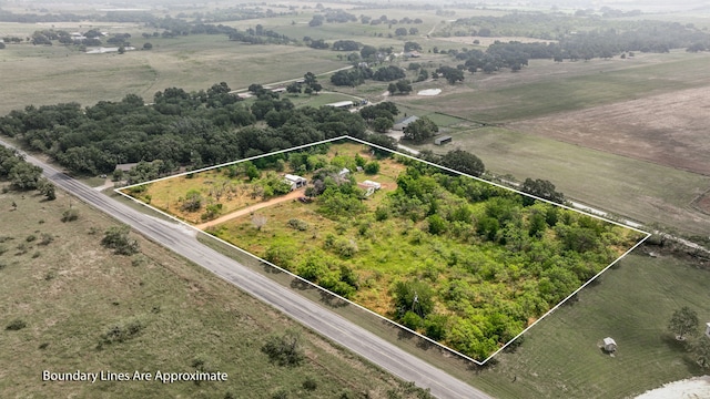 birds eye view of property with a rural view