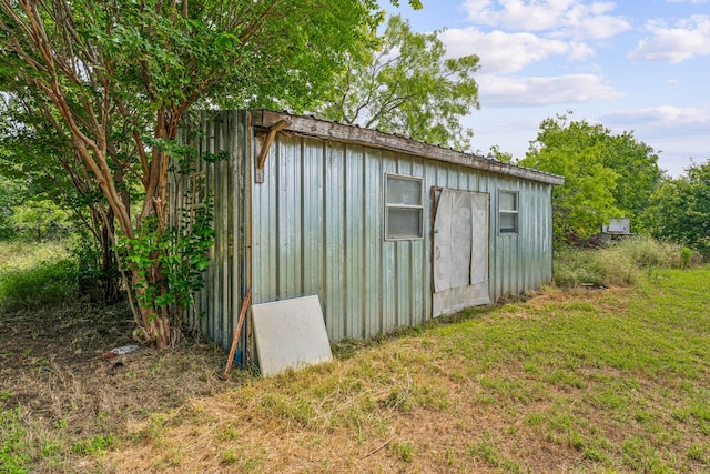 view of outbuilding with a lawn