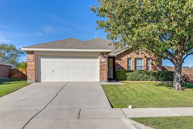 ranch-style house featuring a front lawn and a garage