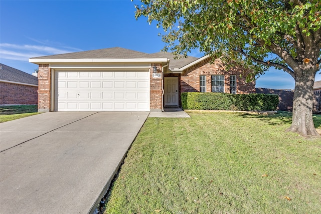 ranch-style house featuring a front yard and a garage