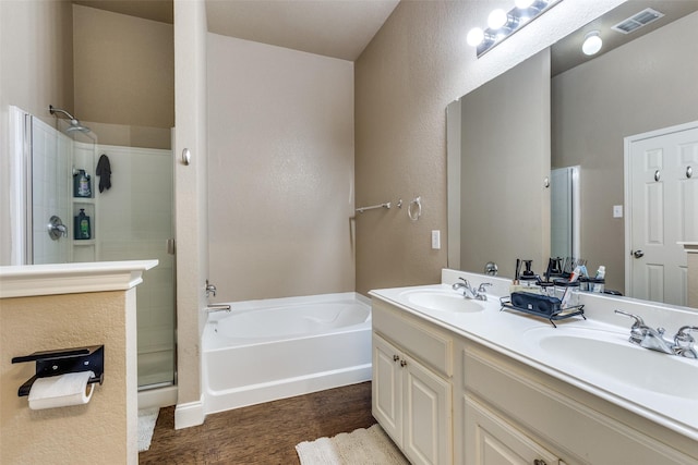 bathroom with shower with separate bathtub and vanity