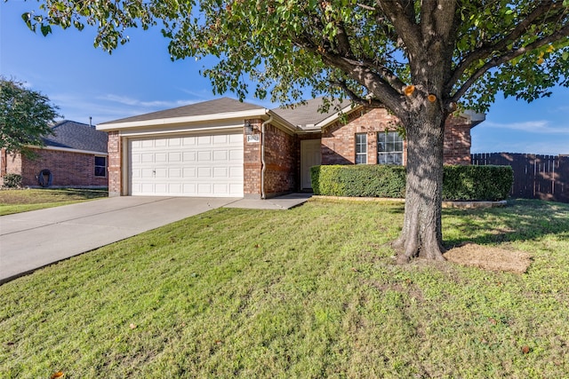 ranch-style home with a garage and a front lawn