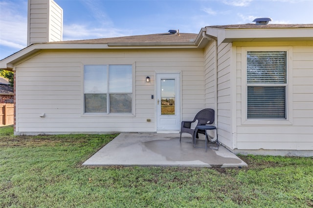 back of property featuring a patio and a lawn