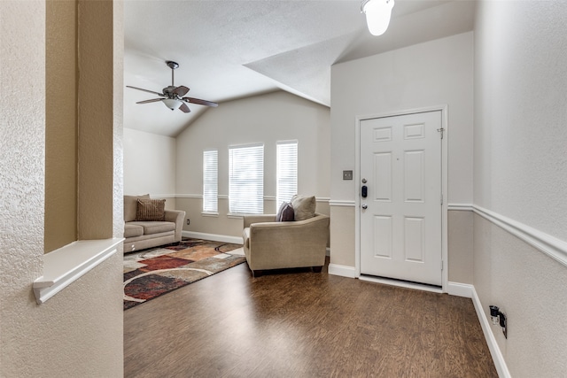 entryway featuring a textured ceiling, ceiling fan, lofted ceiling, and dark wood-type flooring