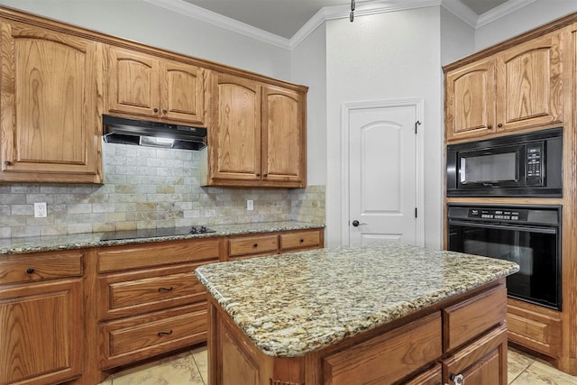 kitchen featuring a kitchen island, tasteful backsplash, ornamental molding, light stone counters, and black appliances