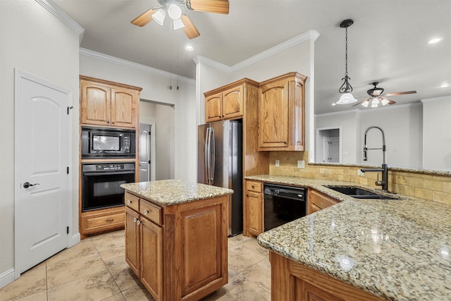 kitchen with sink, light stone counters, decorative light fixtures, a kitchen island, and black appliances