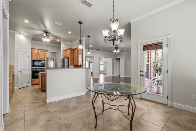 kitchen with ornamental molding, decorative light fixtures, ceiling fan with notable chandelier, and black appliances