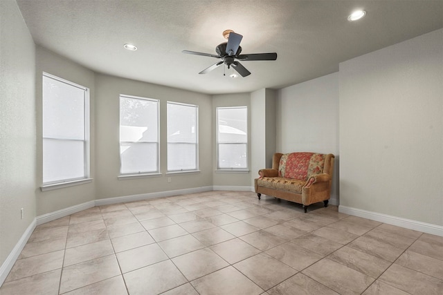 unfurnished room featuring ceiling fan and light tile patterned floors