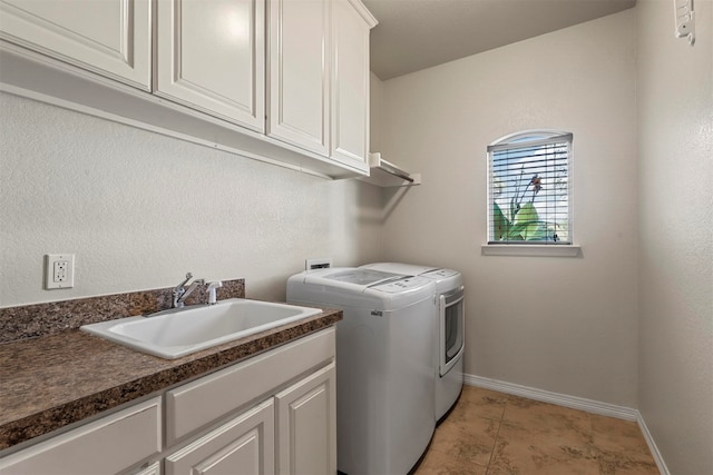 laundry area featuring separate washer and dryer, sink, light tile patterned floors, and cabinets