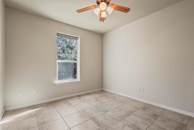 tiled empty room featuring ceiling fan