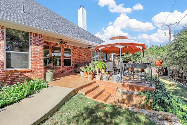 exterior space with a gazebo and ceiling fan