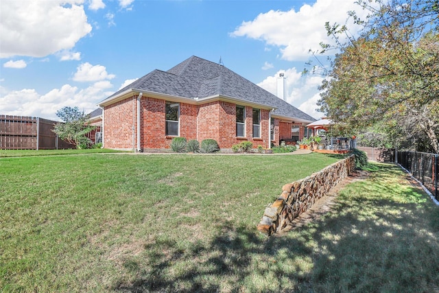 back of house featuring a yard and a gazebo