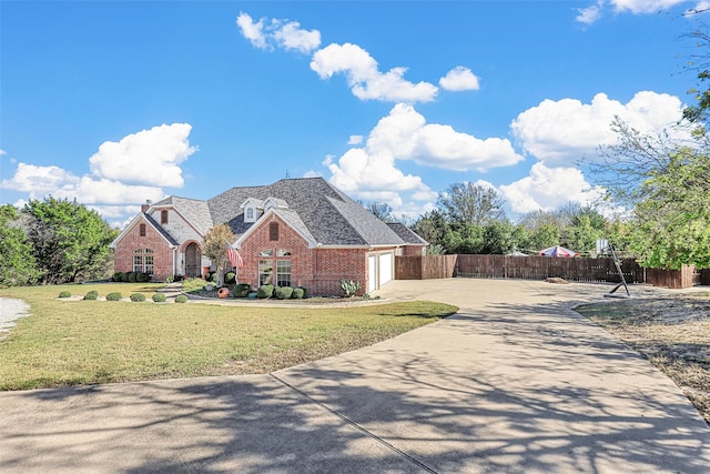 view of front of home featuring a garage and a front yard