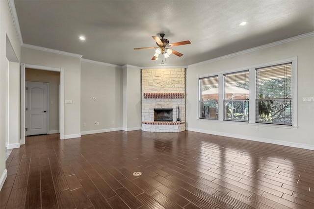 unfurnished living room with ceiling fan, ornamental molding, a stone fireplace, and dark hardwood / wood-style flooring